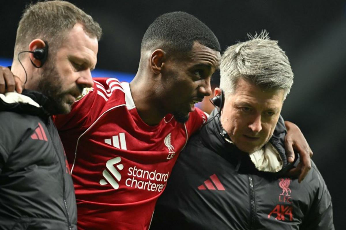 Liverpool's Swedish striker #09 Alexander Isak (C) is helped off the field by medical staff after picking up an injury during the English Premier League football match between Tottenham Hotspur and Liverpool at the Tottenham Hotspur Stadium in London, on December 20, 2025. JUSTIN TALLIS / AFP