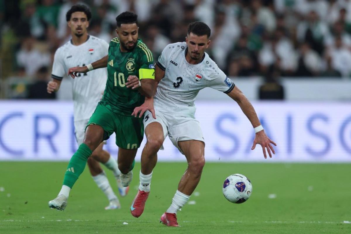 Saudi Arabia's midfielder #10 Salem al-Dawsari is marked by Iraq's defender #3 Hussein Ali during the FIFA World Cup 2026 Asian qualifier football match between Saudi Arabia and Iraq at King Abdullah Sports City in Jeddah on October 14, 2025. AFP