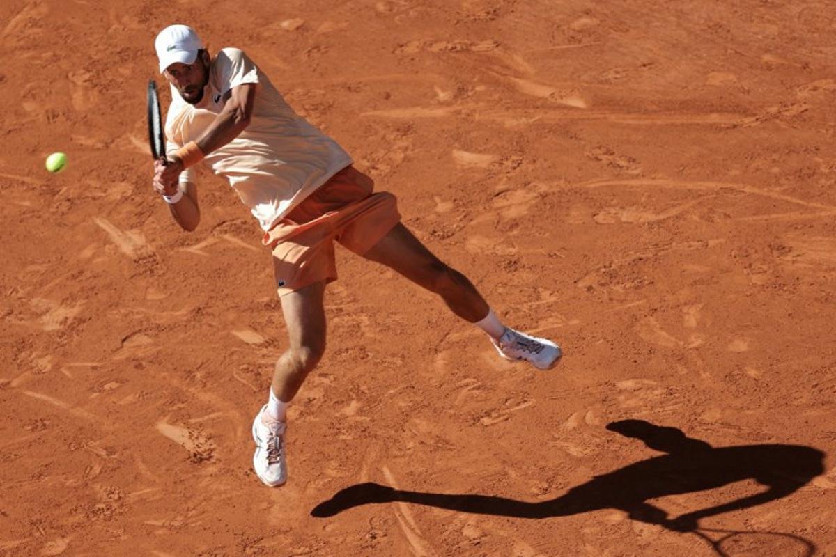 Serbia's Novak Djokovic plays a backhand return to France's Valentin Royer during their men's singles match on day 4 of the French Open tennis tournament on Court Philippe-Chatrier at the Roland-Garros Complex in Paris on May 27, 2026. Thomas SAMSON / AFP
