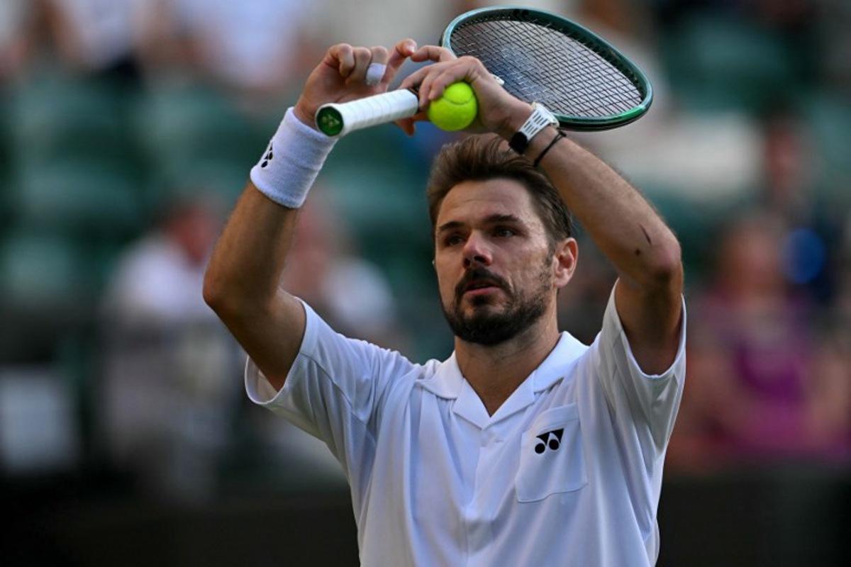 Switzerland's Stan Wawrinka gestures a heart during their men's singles first round tennis match on the second day of the 2026 Wimbledon Championships at The All England Lawn Tennis and Croquet Club in Wimbledon, southwest London, on June 30, 2026. Glyn KIRK / AFP