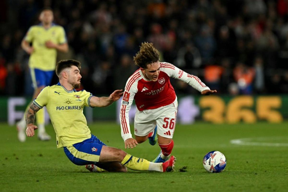 Arsenal's English midfielder #56 Max Dowman is fouled by Southampton's Irish defender #03 Ryan Manning during the English FA Cup quarter final football match between Southampton and Arsenal at St Mary's Stadium in Southampton, southern England on April 4, 2026. Glyn KIRK / AFP