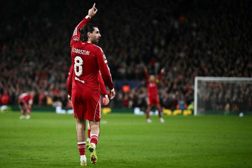 Liverpool's Hungarian midfielder #08 Dominik Szoboszlai celebrates scoring his team's first goal during the UEFA Champions League, round of 16 second leg football match between Liverpool and Galatasaray at Anfield in Liverpool, north-west England on March 18, 2026. Paul ELLIS / AFP