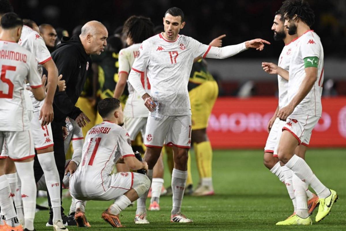 Tunisia's head coach Samy Trabelsi (3 L) speaks to his players during the Africa Cup of Nations (CAN) round of 16 football match between Mali and Tunisia at Mohammed V Stadium in Casablanca on January 3, 2026. Paul ELLIS / AFP