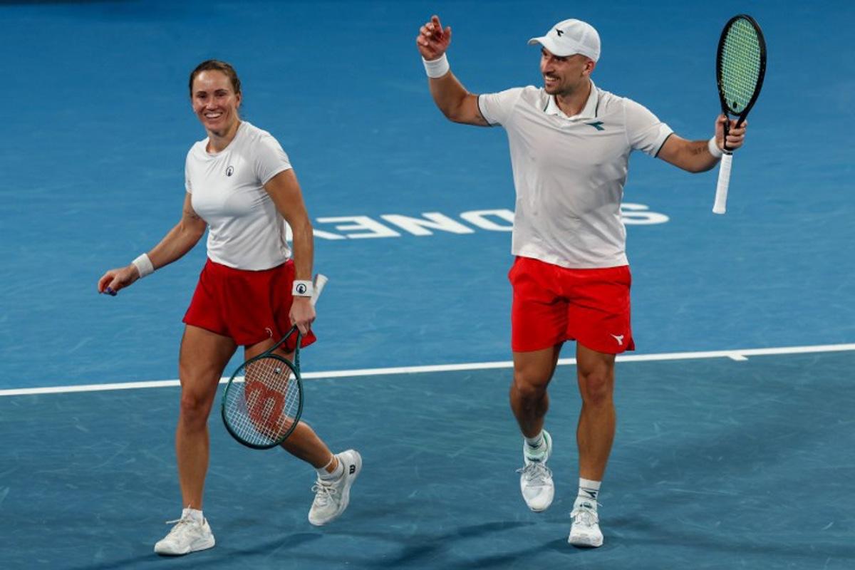 Poland's Jan Zielinski (R) and Katarzyna Kawa celebrate after winning the first set against USA's Coco Gauff and Christian Harrison during their mixed doubles semi-final match at the United Cup tennis tournament in Sydney on January 10, 2026. Izhar KHAN / AFP