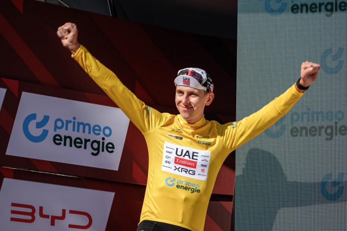 UAE Team Emirates-XRG's Slovenian rider Tadej Pogacar wearing the overall leader's yellow jersey celebrates on the podium of the fourth stage, a 23.7 km time trial from Aarburg to Aarburg, at the Men's Tour of Switzerland (Tour de Suisse) cycling race in Aarburg, Switzerland, on June 20, 2026. Fabrice COFFRINI / AFP