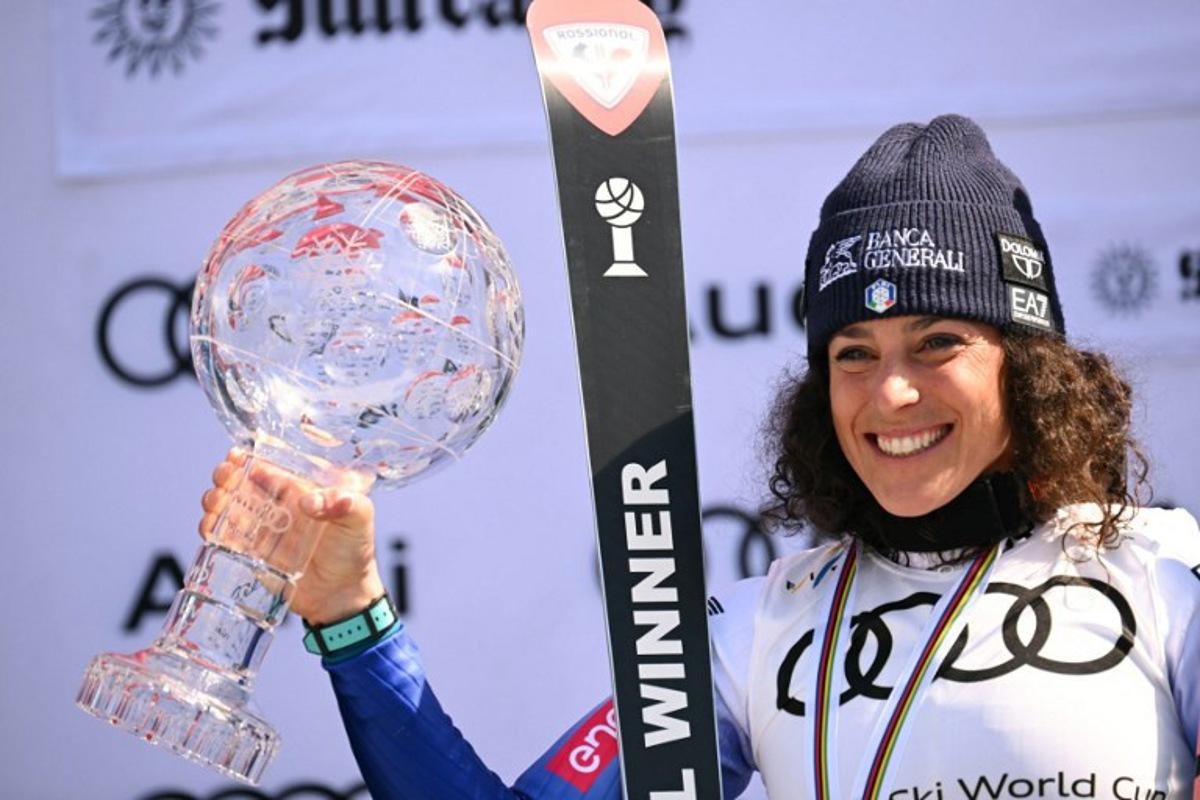 Women's overall winner Federica Brignone celebrates with the crystal globe on the podium at the 2025 FIS Alpine World Cup Finals at Sun Valley Resort in Sun Valley, Idaho, on March 27, 2025. Patrick T. Fallon / AFP