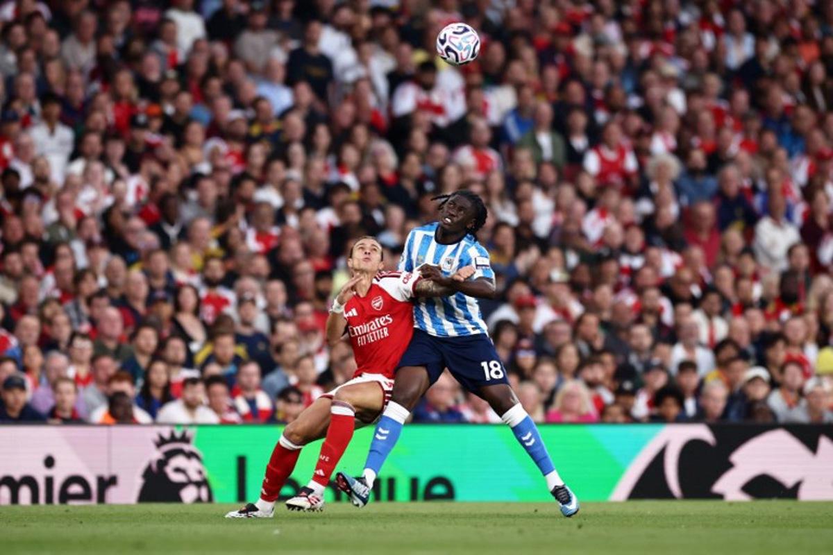 Arsenal's Italian defender #33 Riccardo Calafiori battles for the ball with Coventry City's French midfielder #18 Loum Tchaouna during the English Premier League football match between Arsenal and Coventry City at the Emirates Stadium in London on August 21, 2026. Henry NICHOLLS / AFP