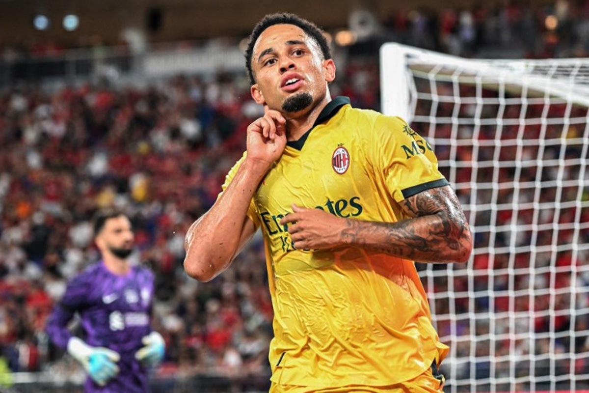 AC Milan's Noah Okafor celebrates after beating Liverpool goalkeeper Alisson Becker (L) to score a goal in their friendly exhibition football match against Liverpool at the Kai Tak Stadium in Hong Kong on July 26, 2025. Peter PARKS / AFP