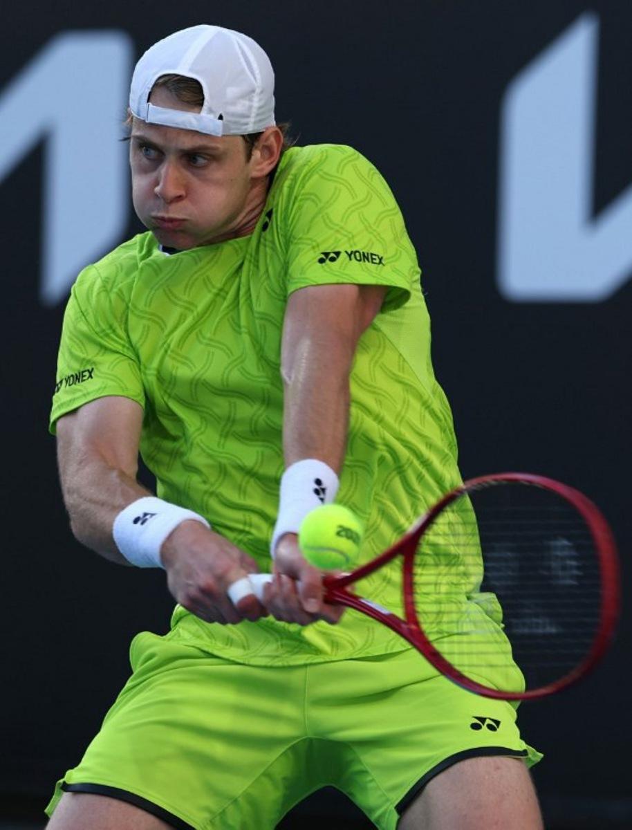 Belgium's Zizou Bergs hits a shot against Poland's Hubert Hurkacz during their men's singles match on day three of the Australian Open tennis tournament in Melbourne on January 20, 2026. IZHAR KHAN / AFP