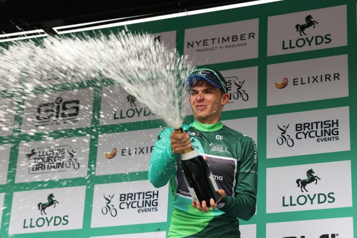 Groupama FGJ's French rider Romain Gregoire sparys the champagne as he celebrate his overall victory in the Tour of Britain cycling race, in Cardiff on September 7, 2025. Darren Staples / AFP