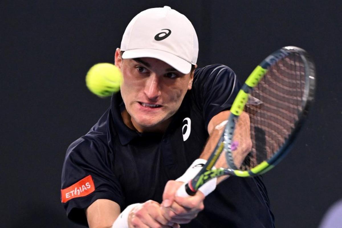 Belgium's Raphael Collignon hits a return to Bulgaria's Grigor Dimitrov during their men's singles match at the Brisbane International tennis tournament in Brisbane on January 8, 2026. William WEST / AFP