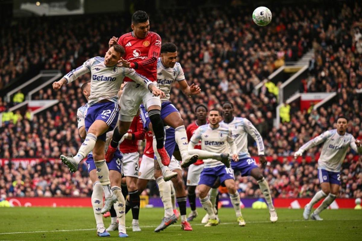 Manchester United's Brazilian midfielder #18 Casemiro (2nd L) heads the ball to score the team's first goal during the English Premier League football match between Manchester United and Aston Villa at Old Trafford in Manchester, north west England, on March 15, 2026. Oli SCARFF / AFP