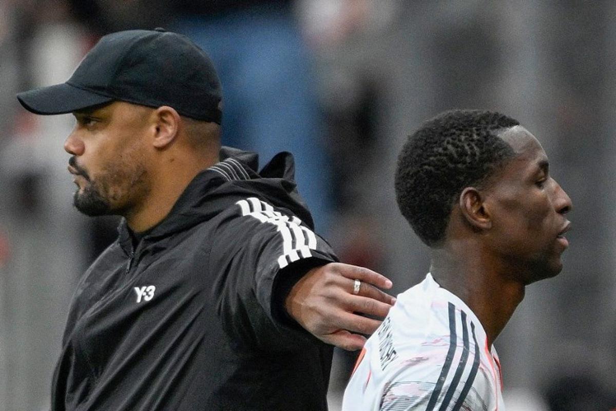 Bayern Munich's Belgian head coach Vincent Kompany (L) greets Bayern Munich's Senegalese forward #11 Nicolas Jackson after he was send off during the German first division Bundesliga football match between Bayer 04 Leverkusen and FC Bayern Munich in Leverkusen, western Germany on March 14, 2026. INA FASSBENDER / AFP