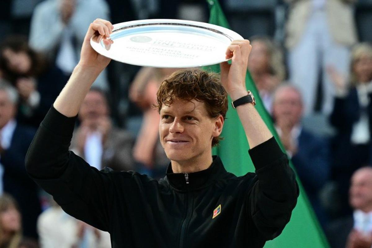 Italy's Jannik Sinner shows his finalist trophy at the end of his men's singles final match against Spain's Carlos Alcaraz for the ATP Rome Open tennis tournament at Foro Italico in Rome on May 18, 2025. Tiziana FABI / AFP