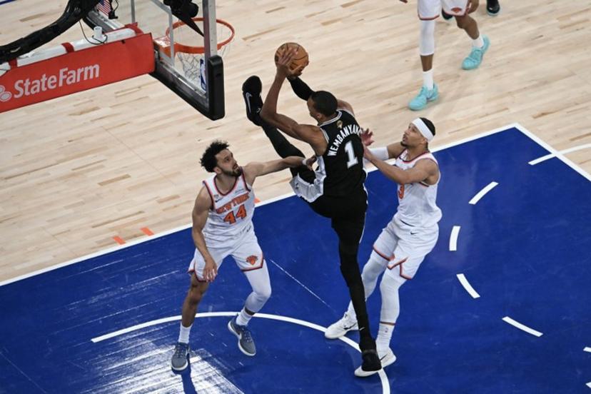 San Antonio Spurs' French forward-center #01 Victor Wembanyama shoots the ball while being defended by Knicks guard #44 Landry Shamet and Knick guard #03 Josh Hart during Game Three of the NBA Finals between the San Antonio Spurs and the New York Knicks at Madison Square Garden in New York on June 8, 2026. SAUL LOEB / AFP