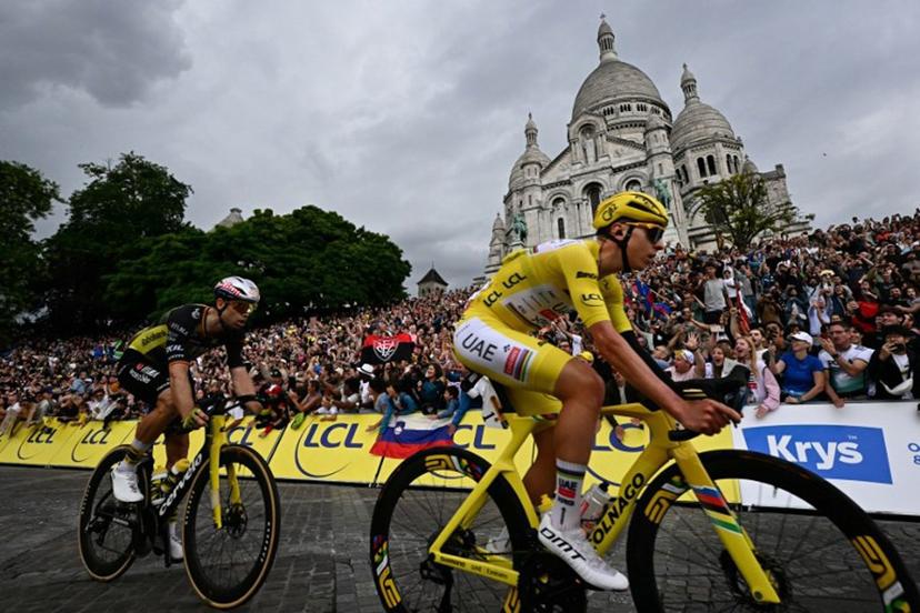 UAE Team Emirates - XRG team's Slovenian rider Tadej Pogacar wearing the overall leader's yellow jersey and Team Visma - Lease a bike team's Belgian rider Wout van Aert cycle past the Sacre-Coeur Basilica on the Butte de Montmartre during the 21st and final stage of the 112th edition of the Tour de France cycling race, 132.3 km between Mantes-la-Ville and Paris' Champs-Elysees Avenue, on July 27, 2025. Loic VENANCE / AFP