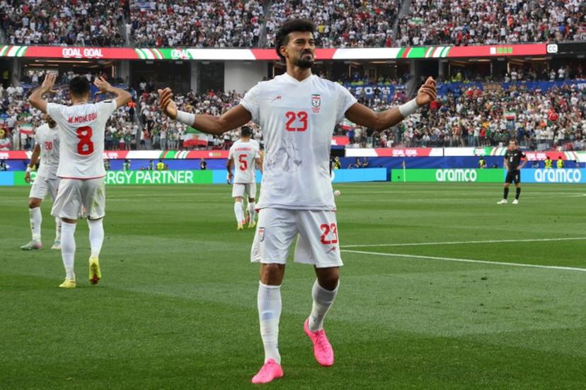 Iran's defender #23 Ramin Rezaeian celebrates scoring his team's first goal during the 2026 World Cup Group G football match between Iran and New Zealand at Los Angeles Stadium in Inglewood on June 15, 2026. Patrick T. Fallon / AFP