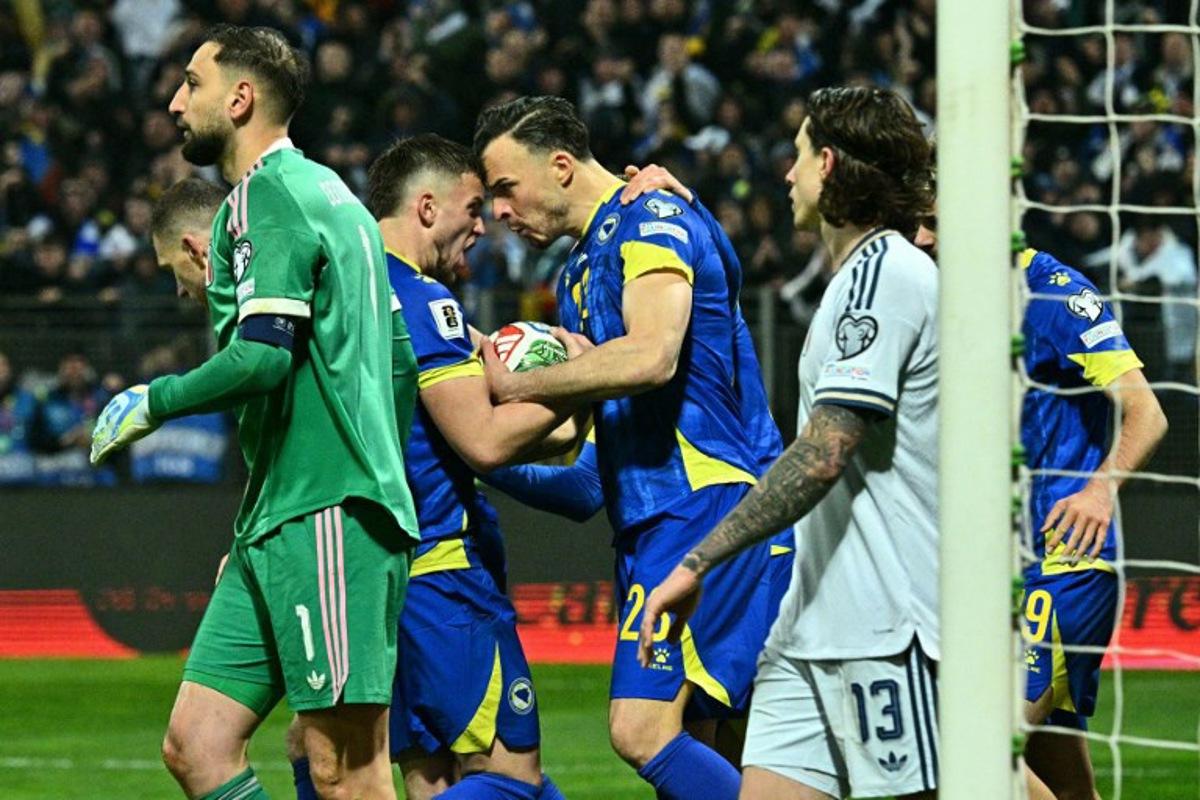 Bosnia-Herzegovina's forward #23 Haris Tabakovic (C) celebrates with teammates after scoring during the FIFA World Cup 2026 European qualification final football match between Bosnia-Herzegovina and Italy at the Bilino-Polje stadium in Zenica on March 31, 2026. Elvis BARUKCIC / AFP