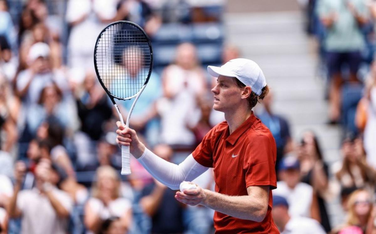 Italy's Jannik Sinner (L) celebrates defeating Australia's Alexei Popyrin in their men's singles second round match against on day five of the US Open tennis tournament at the USTA Billie Jean King National Tennis Center in New York City on August 28, 2025. Kena Betancur / AFP