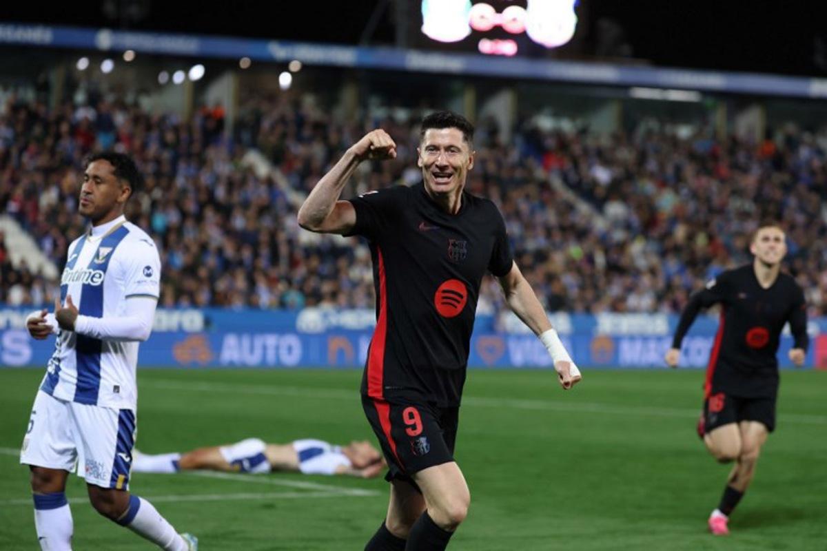 Barcelona's Polish forward #09 Robert Lewandowski celebrates after Leganes' Spanish defender #03 Jorge Saenz scored an own goal during the Spanish league football match between Club Deportivo Leganes SAD and FC Barcelona at the Estadio Municipal Butarque in Leganes, near Madrid, on April 12, 2025. Thomas COEX / AFP