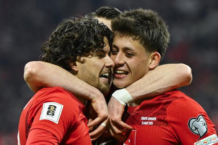 Turkey's defender #20 Ferdi Kadioglu (L) celebrates with Turkey's midfielder #08 Arda Guler (R) after scoring his team first goal during the play-off FIFA World Cup 2026 European qualification knockout semi-final football match between Turkey and Romania at Besiktas Park stadium, in Istanbul on March 26, 2026. YASIN AKGUL / AFP