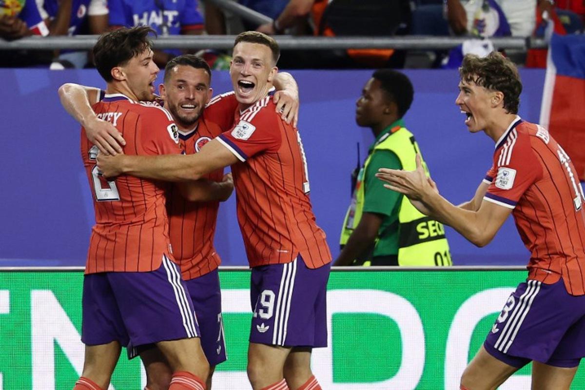 Scotland's midfielder #07 John McGinn (2nd L) celebrates with teammates after scoring his team's first goal during the 2026 World Cup Group C football match between Haiti and Scotland at the Boston Stadium in Foxborough on June 13, 2026. FRANCK FIFE / AFP