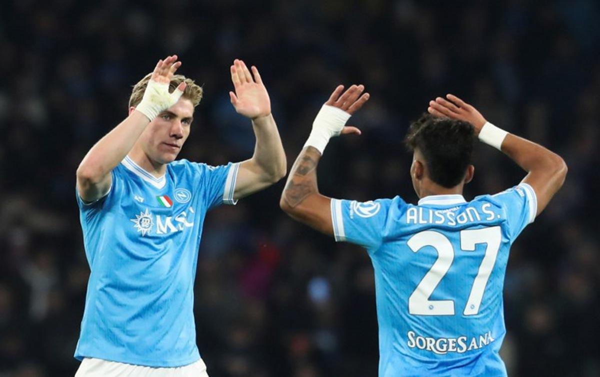 Napoli's Danish forward Rasmus #19 Hojlund celebrates with teammate Napoli's Brazilian forward #27 Allison Santos after scoring his team's first goal during the Italian Serie A football match between Napoli and Lecce at the Diego Armando Maradona stadium in Naples, southern Italy, on March 14, 2026. CARLO HERMANN / AFP