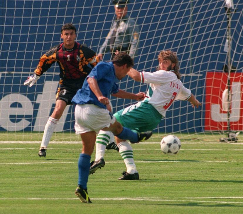 Italian forward Roberto Baggio kicks the ball past Bulgarian defender Trifon Ivanov and goalkeeper Borislav Mihaylov to score his first goal during the World Cup semifinal soccer match between Italy and Bulgaria 13 July 1994 in East Rutherford. Baggio scored another goal to help his team qualify for the final with a 2-1 victory. AFP PHOTO/BOB STRONG BOB STRONG / AFP