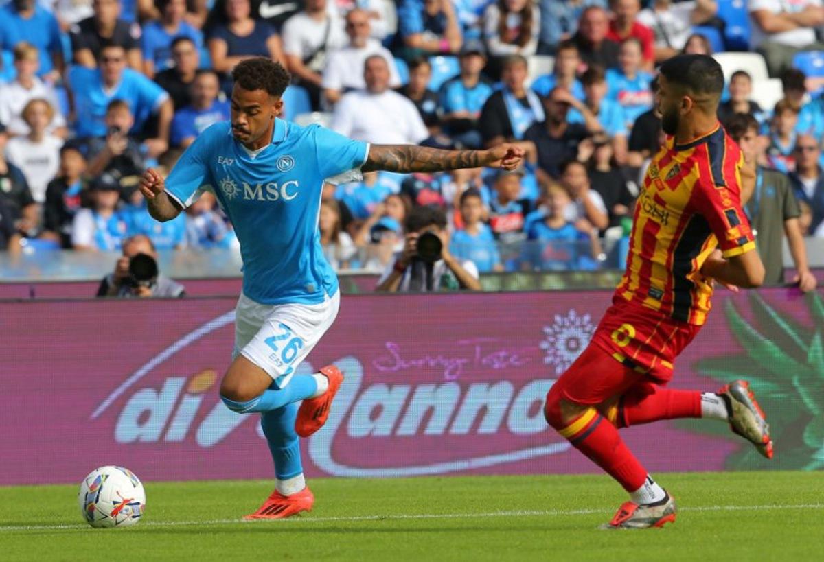Napoli's Belgian forward #26 Cyril Ngonge fights for the ball with Lecce's Montenegrin forward #09 Nikola Krstovic during the Italian Serie A football match between Napoli and Lecce at the Diego Armando Maradona stadium in Naples on October 26, 2024. CARLO HERMANN / AFP