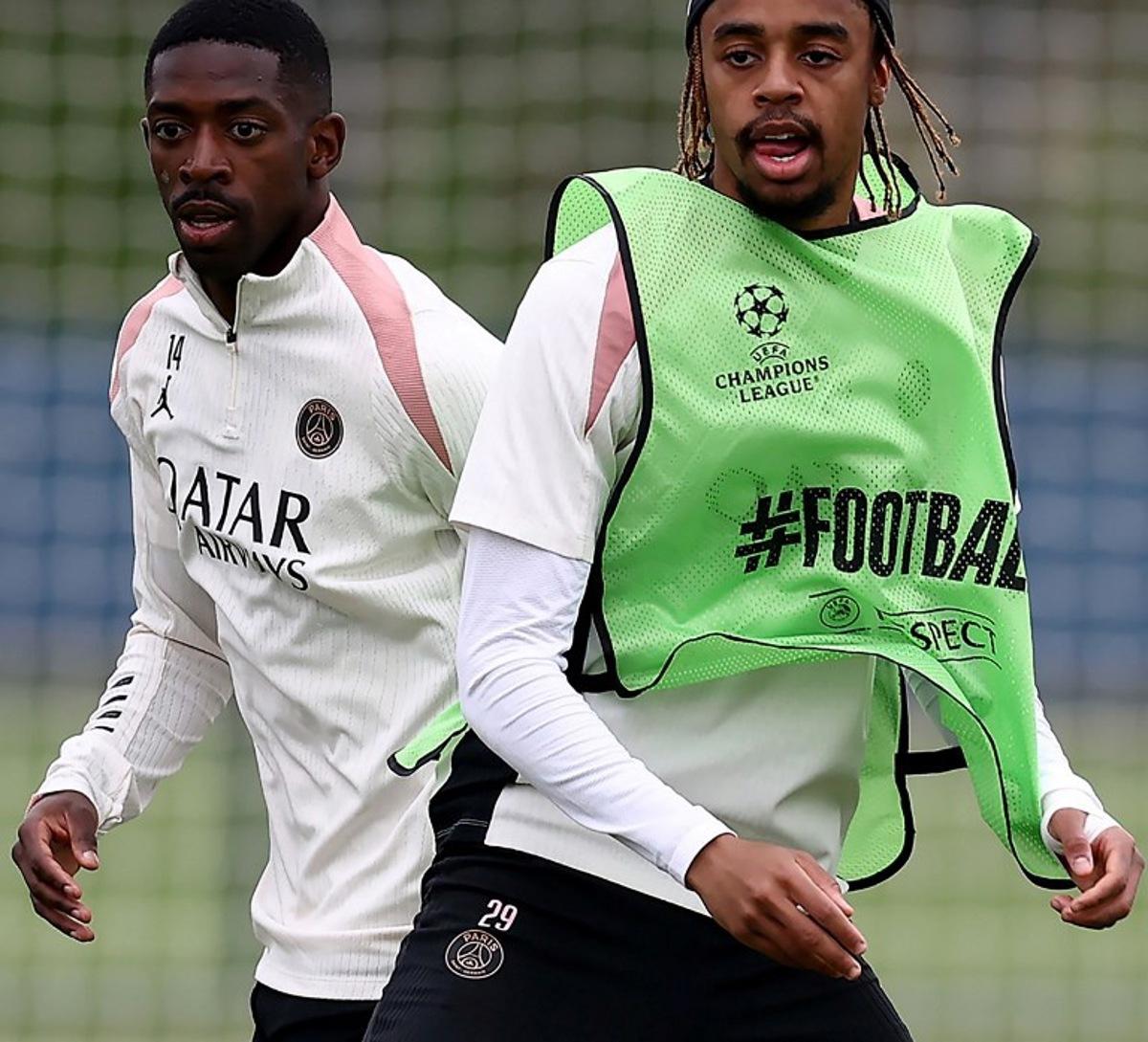 Paris Saint-Germain's French forward #10 Ousmane Dembele (L) and Paris Saint-Germain's French forward #29 Bradley Barcola (R) attend a training session ahead of the UEFA Champions League final football match at the club training camp in Poissy, west of Paris, on May 21, 2025. PSG will play the French Cup final football match against Stade de Reims on May 24, 2025 and Champions League's against Inter Milan on May 31, 2025. FRANCK FIFE / AFP