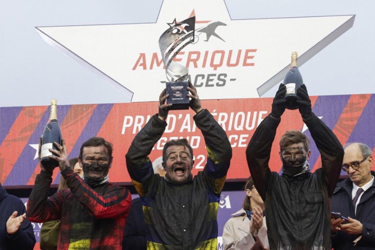 (From L) Second-placed French jockey Sebastien Ernault driver of Josh Power, winner French jockey Franck Nivard, driver of Hokkaido Jiel and third-placed French jockey Paul Philippe Ploquin driver of Epic Kronos celebrate on the podium after the 105th Grand Prix d'Amerique harness racing horse race at the Vincennes Hippodrome in Paris on January 25, 2026. GEOFFROY VAN DER HASSELT / AFP