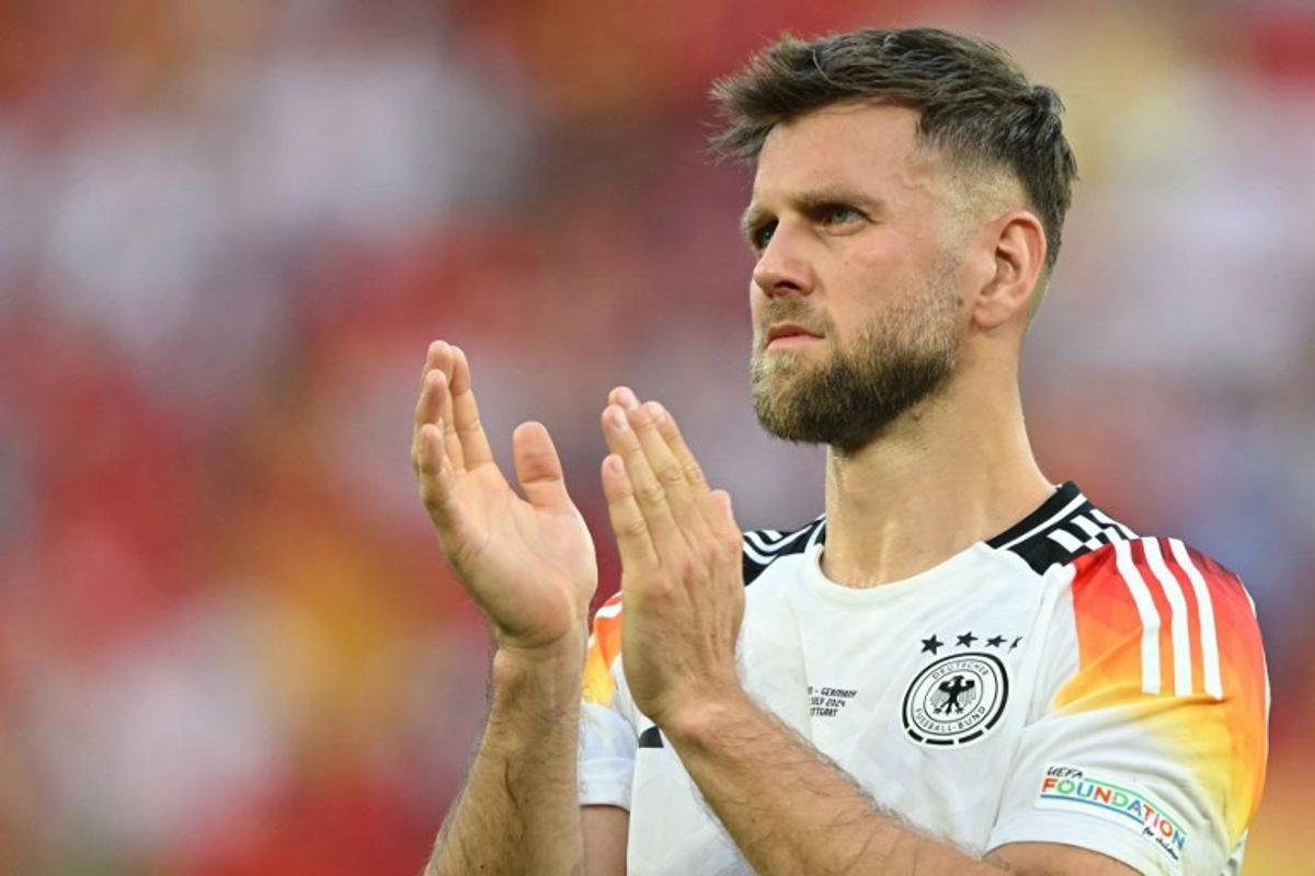 Germany's forward #09 Niclas Fullkrug applauds the fans after the UEFA Euro 2024 quarter-final football match between Spain and Germany at the Stuttgart Arena in Stuttgart on July 5, 2024. Fabrice COFFRINI / AFP