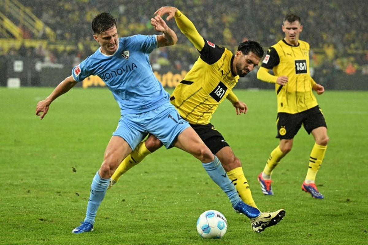 Bochum's German defender #14 Tim Oermann (L) and Dortmund's German midfielder #23 Emre Can vie for the ball during the German first division Bundesliga football match between BVB Borussia Dortmund and VfL Bochum in Dortmund, western Germany on September 27, 2024. INA FASSBENDER / AFP