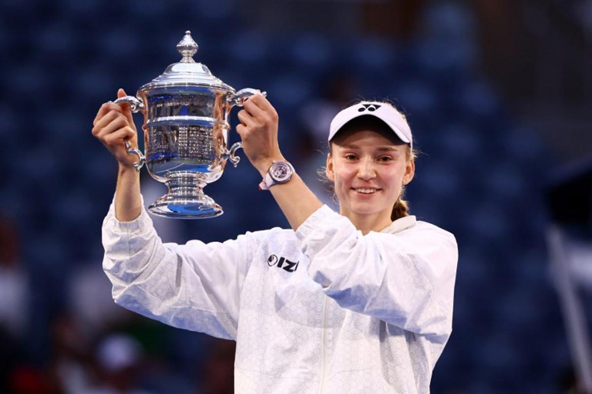 Kazakhstan's Elena Rybakina holds up the winner's trophy after winning the women's singles final tennis match against Belarus's Aryna Sabalenka on day fourteen of the US Open tennis tournament at the USTA Billie Jean King National Tennis Center in New York City on September 12, 2026. CHARLY TRIBALLEAU / AFP