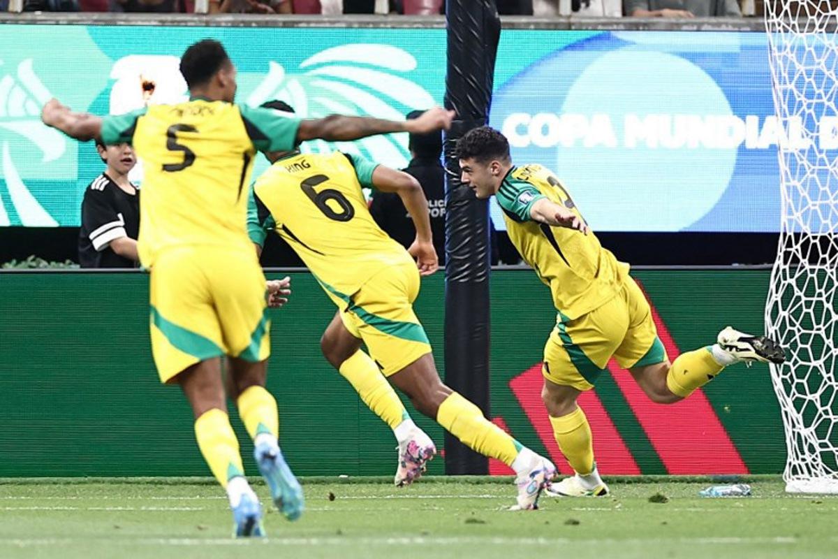 Jamaica's forward #09 Bailey Cadamarteri (R) celebrates with teammates defender #06 Richard King and midfielder #05 Ethan Pinnock after scoring the opening goal during the 2026 FIFA World Cup qualifiers semi-final playoff football match between New Caledonia and Jamaica at the Akron Stadium in Zapopan, Mexico on March 26, 2026. Ulises Ruiz / AFP