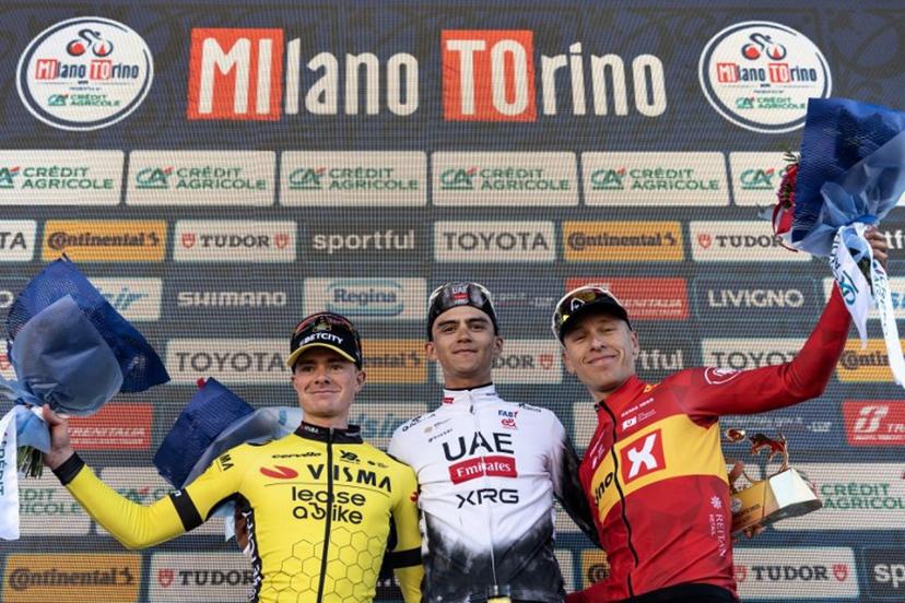 Second-placed Team Visma Lease a Bike, British Ben Tulett (L), winner Mexican Isaac Del Toro (C) and third Team Uno X Mobility Jonas Abrahamsen of Norway celebrate on the podium of the 106th edition of the one-day classic cycling race Milan - Torino between Rho, west of Milan, and Superga, east of Torino, on March 19, 2025. MARCO BERTORELLO / AFP