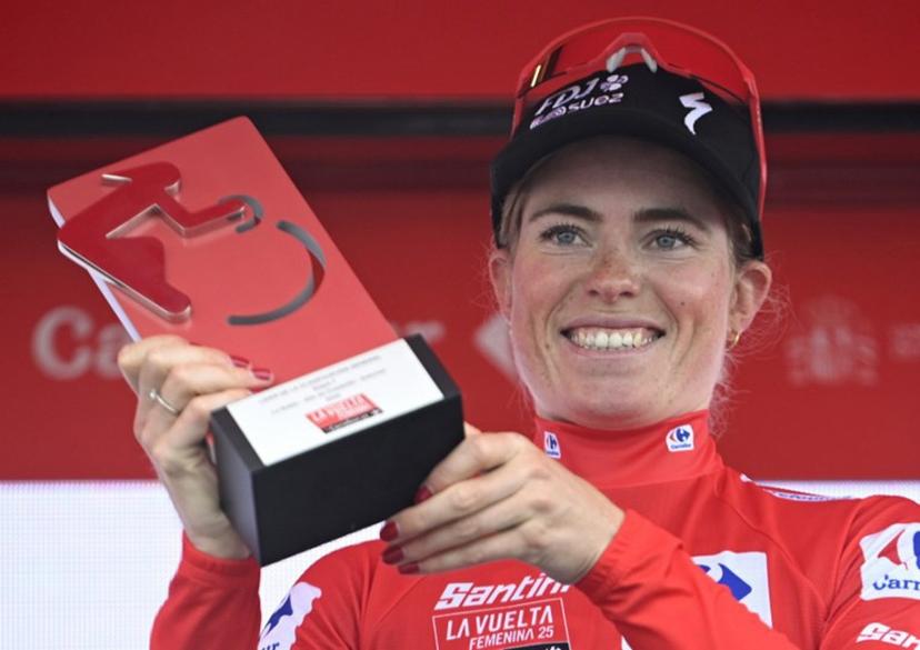 Overall leader FDJ-Suez team's Dutch rider Demi Vollering wearing the red jersey celebrates on the podium after the 7th stage of the 2025 La Vuelta Femenina cycling tour of Spain, a 152.6 km race from La Robla to Cotobello, on May 10, 2025. MIGUEL RIOPA / AFP