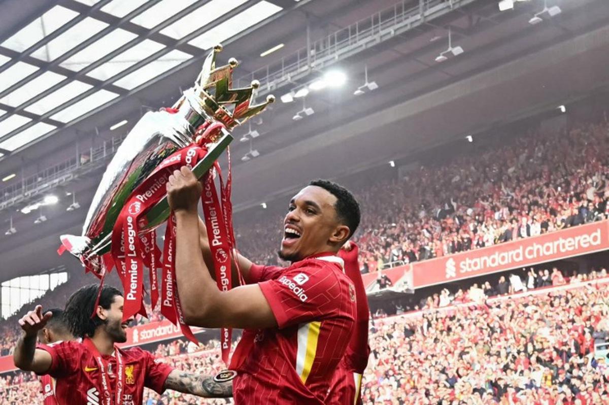 Liverpool's English defender #66 Trent Alexander-Arnold celebrates with the Premier League trophy at the end of the English Premier League football match between Liverpool and Crystal Palace at Anfield in Liverpool, north west England on May 25, 2025. Liverpool equalises 1 - 1 against Crystal Palace. Paul ELLIS / AFP