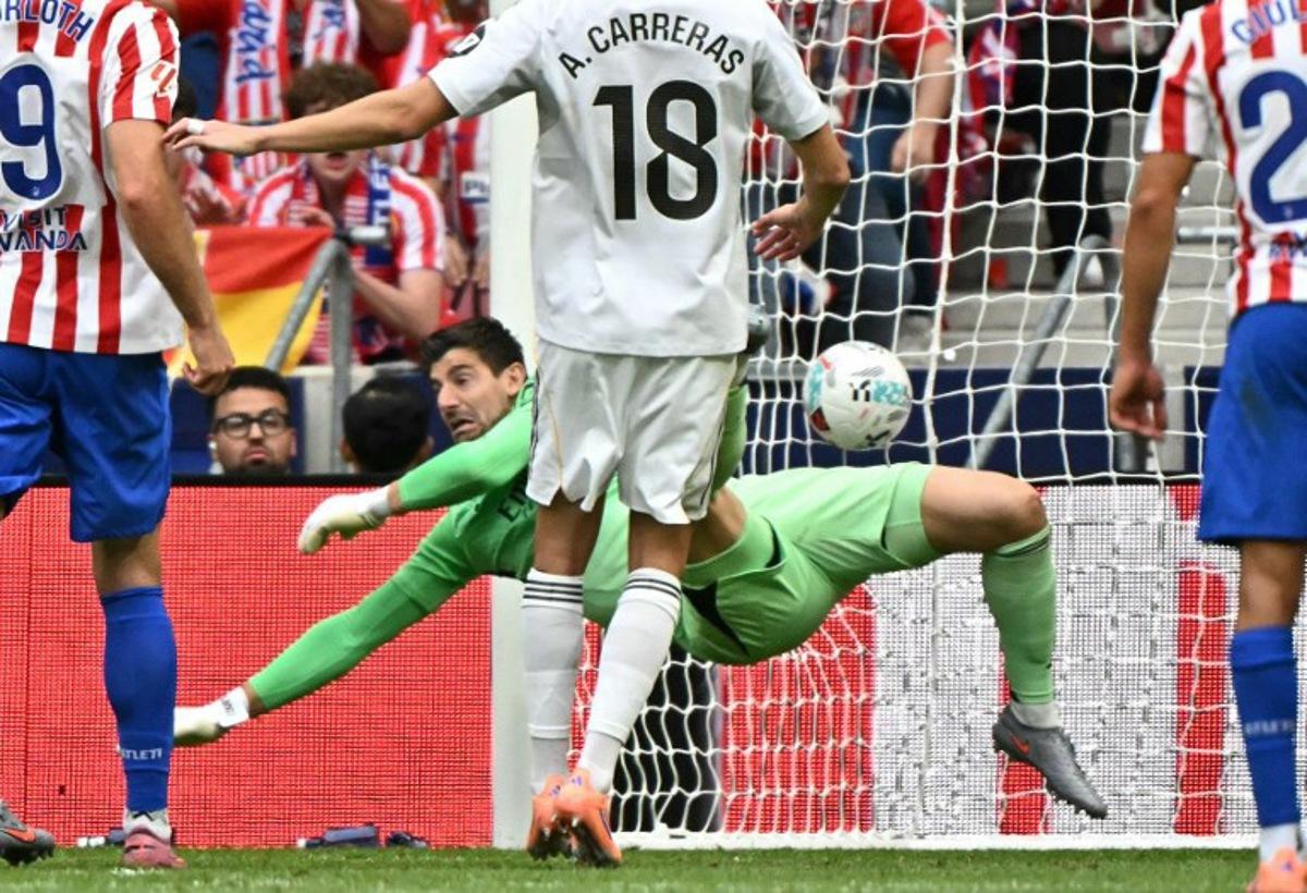 Atletico Madrid's Argentine forward #19 Julian Alvarez scores his team's fourth goal in spite of Real Madrid's Belgian goalkeeper #01 Thibaut Courtois during the Spanish league football match between Club Atletico de Madrid and Real Madrid CF at the Metropolitano stadium in Madrid on September 27, 2025. Javier SORIANO / AFP