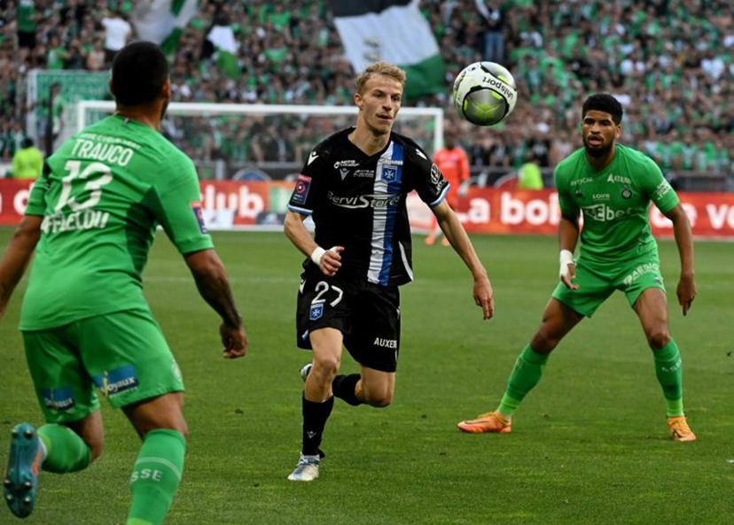 Auxerre's French midfielder Alexis Trouillet (C) fights for the ball with Saint-Etienne's Peruvian defender Miguel Trauco (L) and Saint-Etienne's French midfielder Mahdi Camara during the French L1-L2 play-off football match between AS Saint-Etienne and AJ Auxerre at the Geoffroy Guichard Stadium in Saint-Etienne, central-eastern France on May 29, 2022. JEAN-PHILIPPE KSIAZEK / AFP
