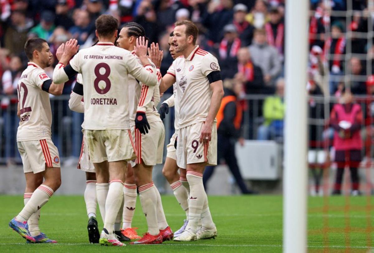 Bayern Munich's English forward #09 Harry Kane (R) celebrates with teammates after scoring the 1-0 opening goal during the German first division Bundesliga football match between Bayern Munich and St Pauli in Munich, southern Germany on March 29, 2025. Alexandra BEIER / AFP