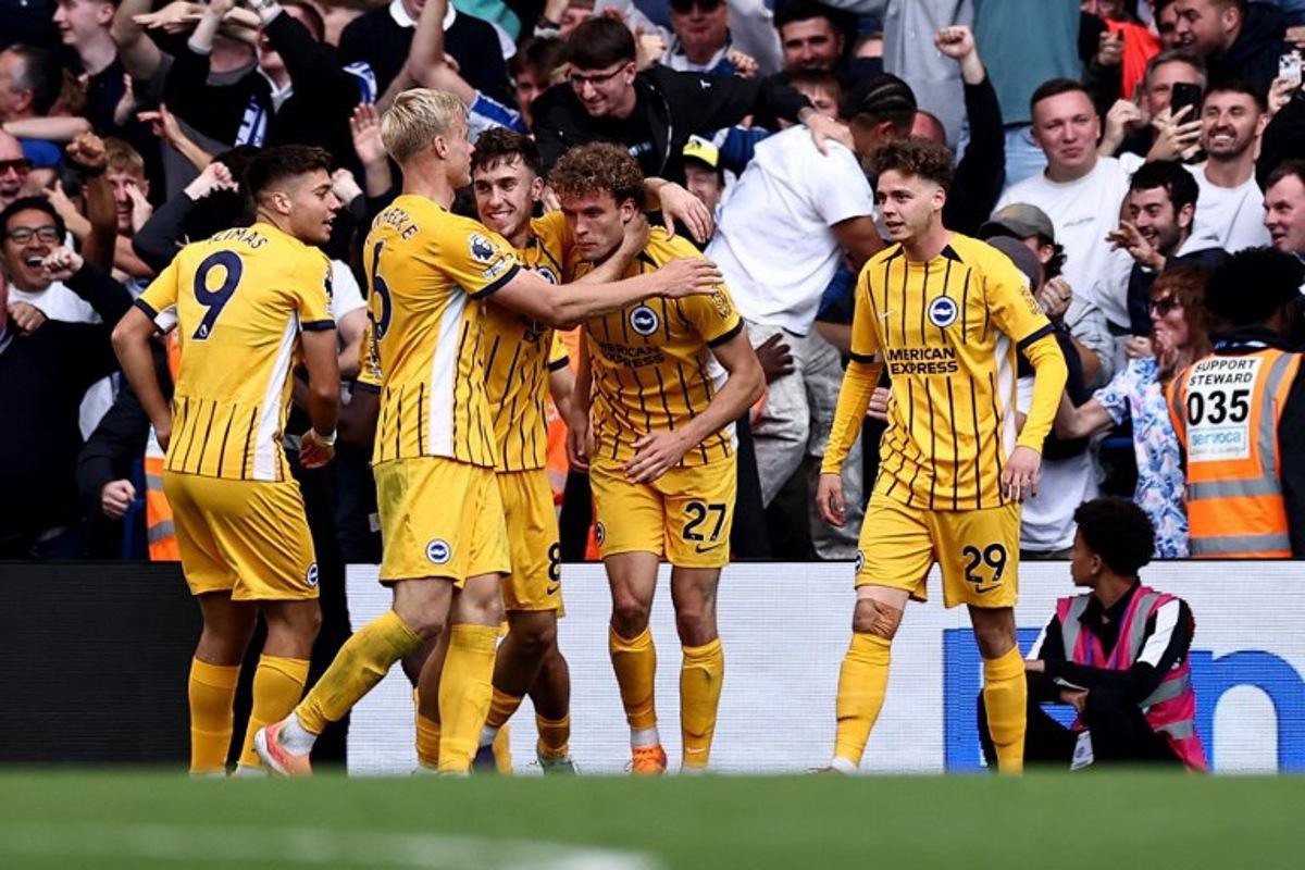 Brighton's Belgian defender #29 Maxim De Cuyper (R) celebrates scoring the team's second goal during the English Premier League football match between Chelsea and Brighton and Hove Albion at Stamford Bridge in London on September 27, 2025. HENRY NICHOLLS / AFP