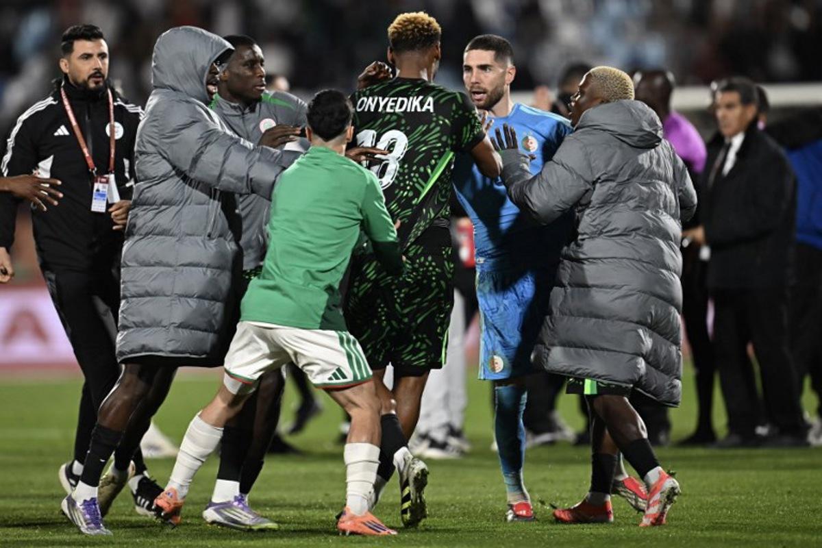 Nigeria's midfielder #18 Raphael Onyedika, Algeria's goalkeeper #23 Luca Zidane and players argue during the Africa Cup of Nations (CAN) quarter-final football match between Algeria and Nigeria at the Grand stadium in Marrakesh on January 10, 2026. Paul ELLIS / AFP