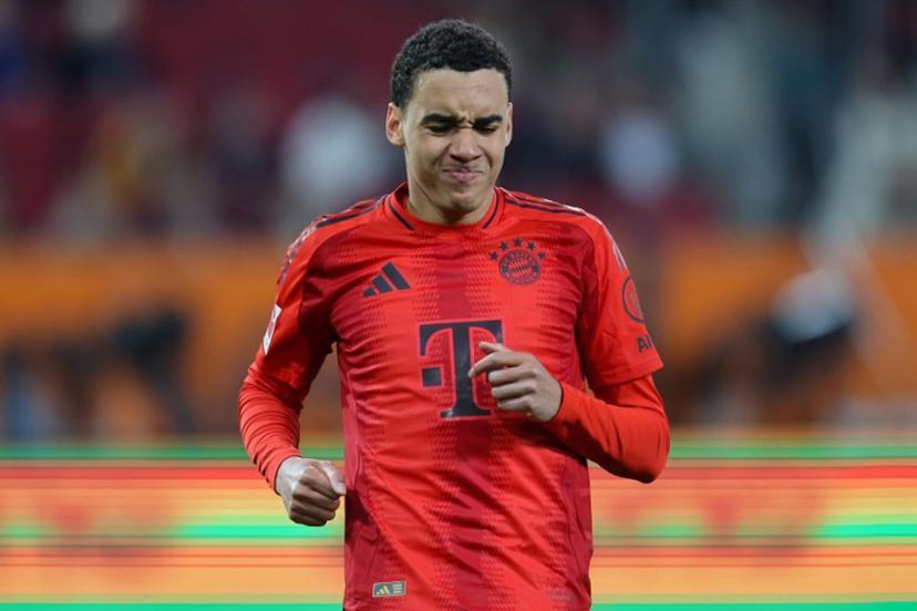 Bayern Munich's German midfielder #42 Jamal Musiala reacts after sustaining an injury during the German first division Bundesliga football match between FC Augsburg and FC Bayern Munich in Augsburg, southern Germany, on April 4, 2025. Alexandra BEIER / AFP