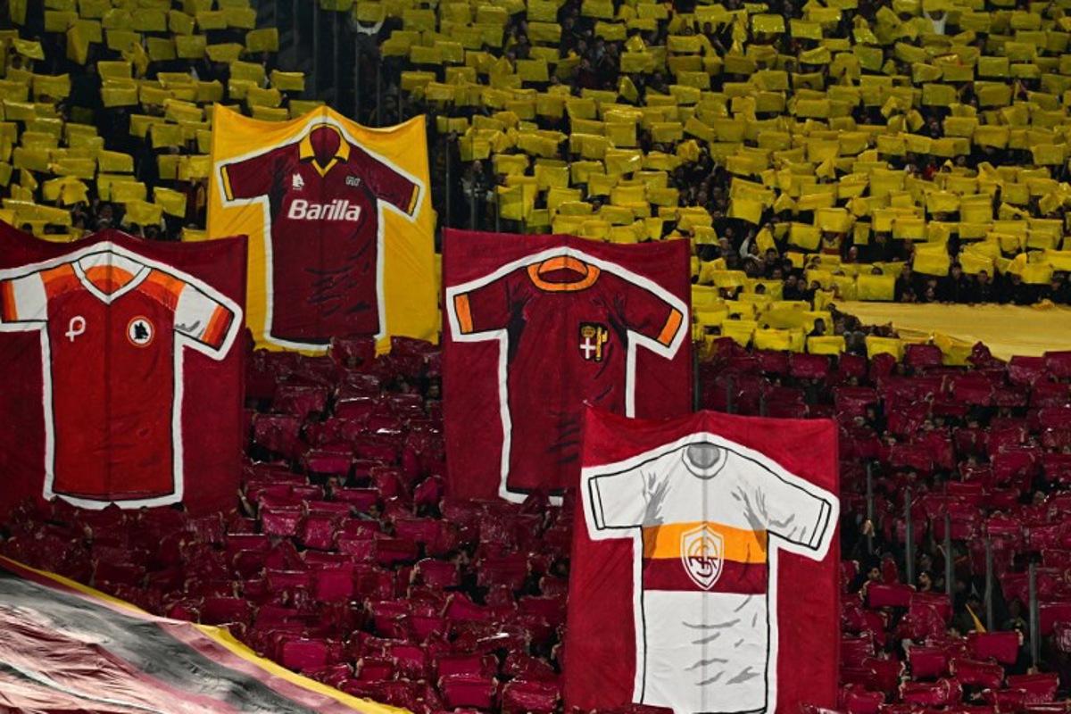 AS Roma's supporters take part in the pre-match show before the Italian Serie A football match between Lazio and Roma at the Olympic Stadium in Rome on April 13, 2025. Tiziana FABI / AFP