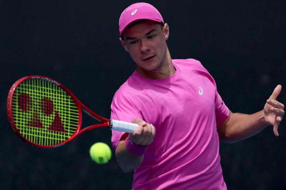 Poland's Kamil Majchrzak hits a return to Hungary's Fabian Marozsan during their men's singles match on day four of the Australian Open tennis tournament in Melbourne on January 21, 2026. Martin KEEP / AFP