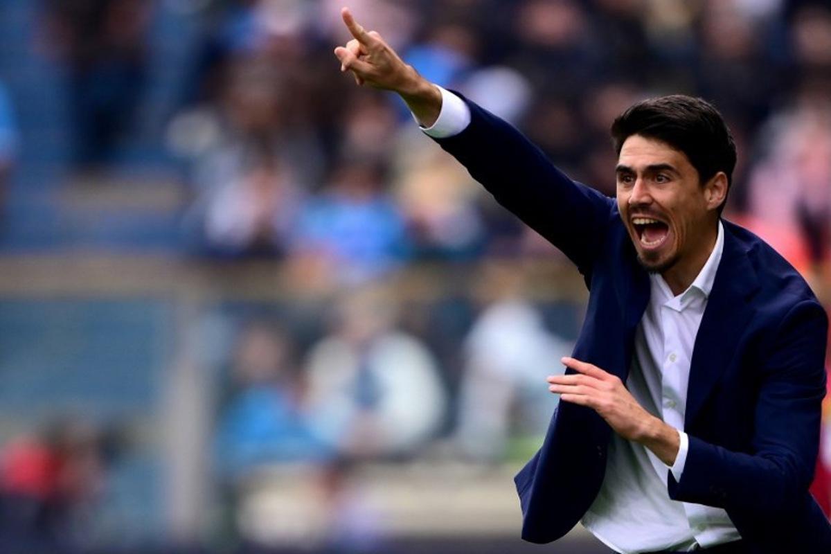 Parma's Spanish coach Carlos Cuesta shouts instructions to his players from the touchline during the Italian Serie A football match between Parma Calcio 1913 and SSC Napoli at the Ennio Tardini Stadium in Parma on April 12, 2026. MARCO BERTORELLO / AFP