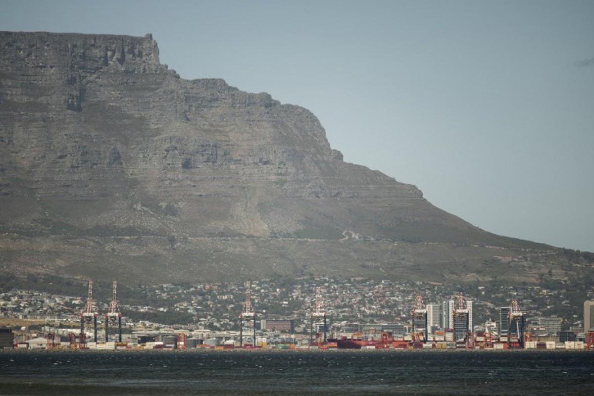 A general view of Table Mountain and the Cape Town City bowl is seen on December 18, 2025. Nestled between spectacular mountains and the Atlantic Ocean, Cape Town has emerged as a growing tourism destination, topping in 2025 the Telegraph and Time Out magazine's rankings of best cities in the world. Activists say the drive to profit from tourism accommodation is pricing locals out of coveted neighbourhoods, including areas near District Six -- a site long associated with the apartheid-era removals that displaced non-white communities to remote, underdeveloped townships. GIANLUIGI GUERCIA / AFP