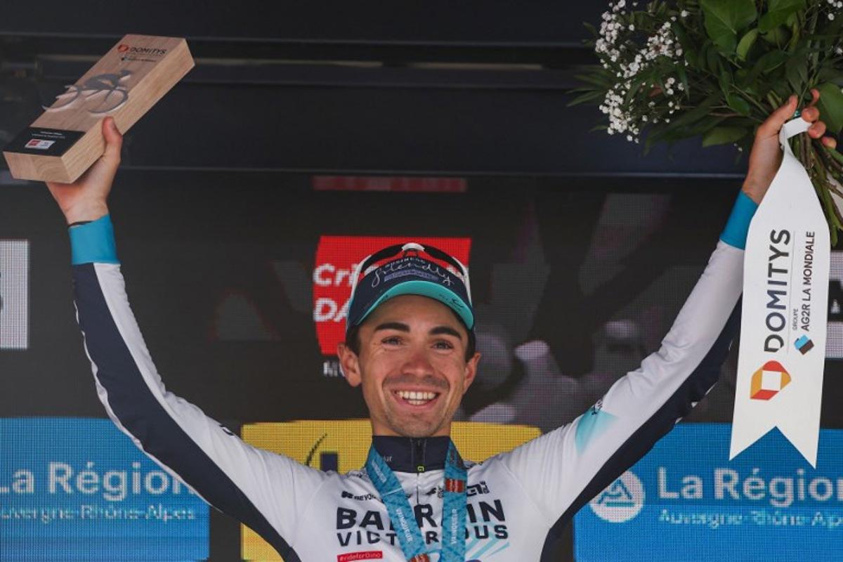 Bahrain Victorious's French rider Lenny Martinez celebrates winning the stage on the podium of the 8th and final stage of the 77th edition of the Criterium du Dauphine cycling race, 133,3 km between Val-d'Arc and Val-Cenis - Plateau du Mont Cenis, on June 15, 2025. Anne-Christine POUJOULAT / AFP