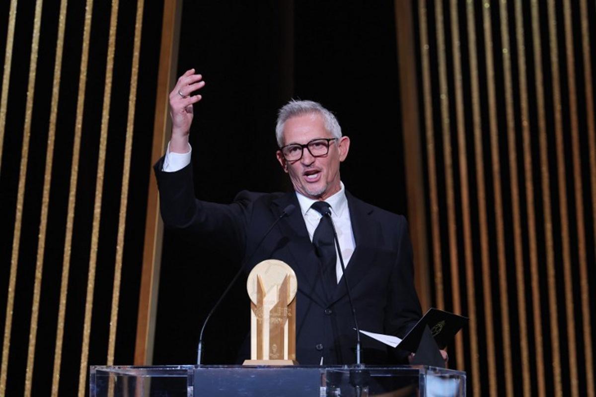 Gary Lineker, former England footballer turned sports TV presenter, gestures on stage with the Gerd Muller Trophy for best striker during the 2023 Ballon d'Or France Football award ceremony at the Theatre du Chatelet in Paris on October 30, 2023. FRANCK FIFE / AFP